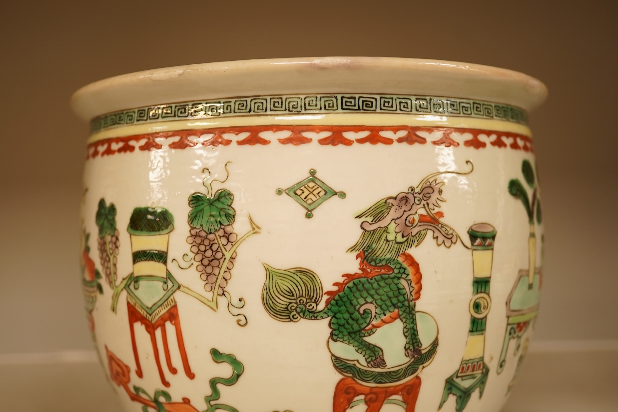 A Chinese Hundred Antiques famille verte small jardiniere, 19th century, 17cm high, 21cm diameter.